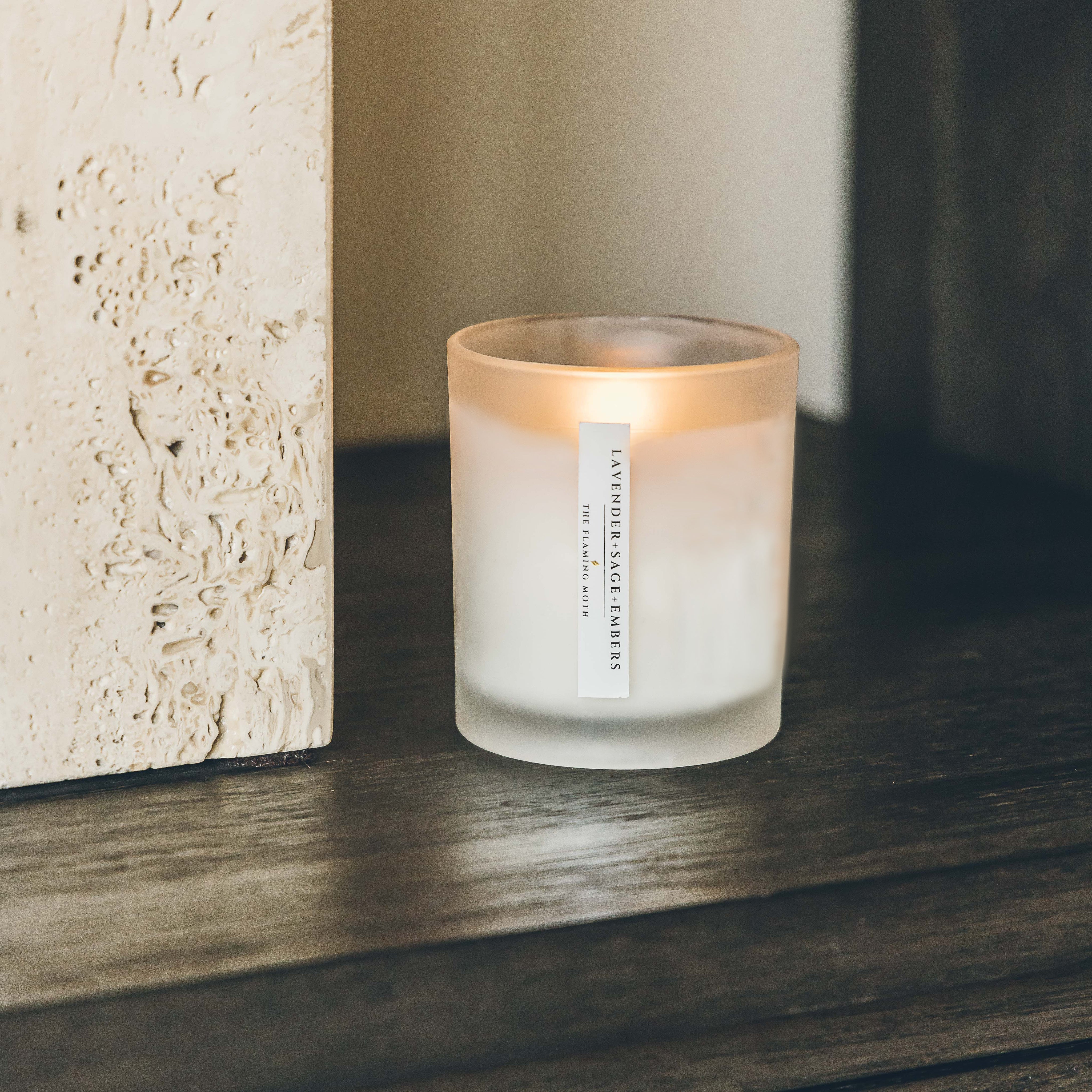 lavender sage embers candle on wood credenza limestone pillar