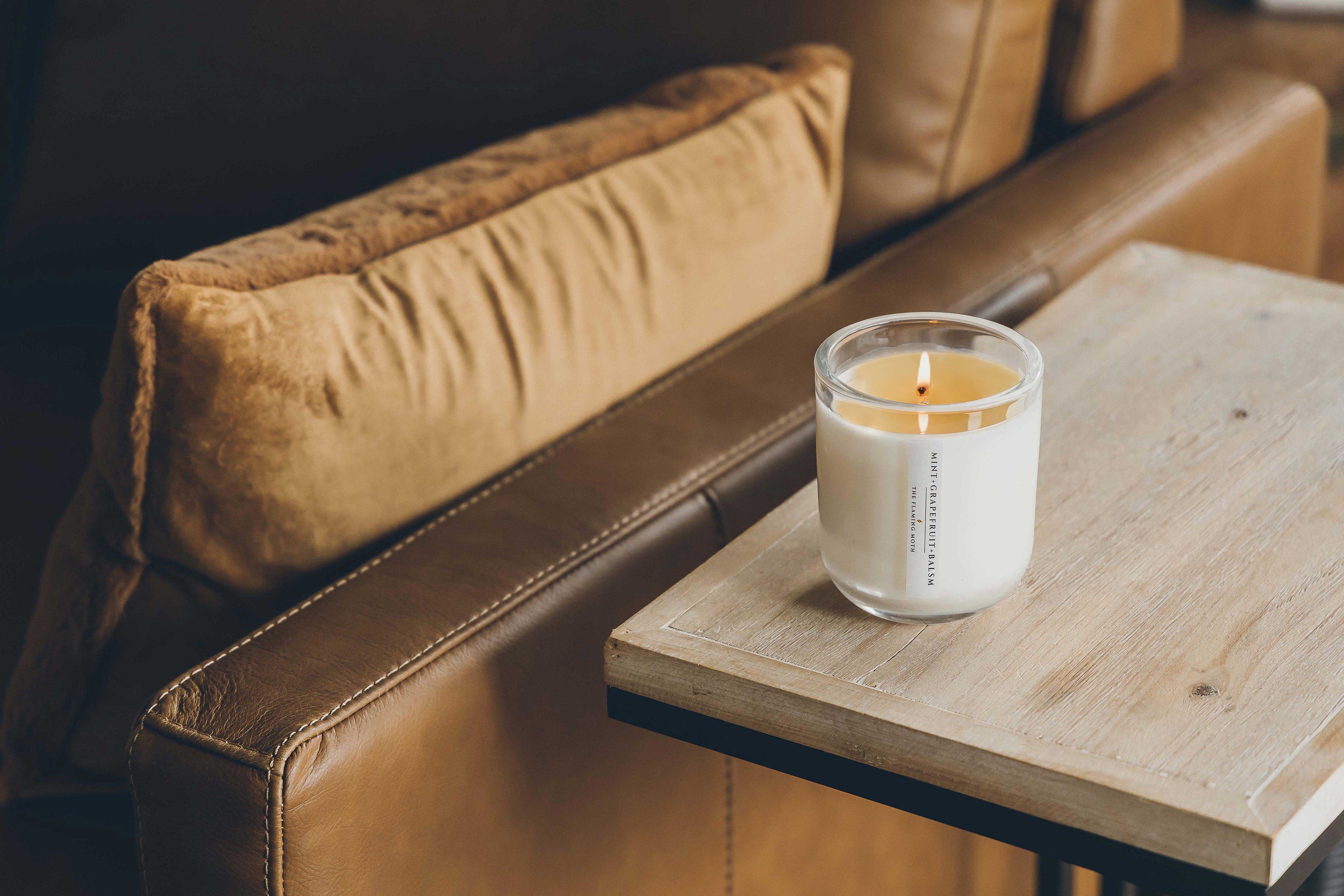 mint grapefruit balsam candle burning on end table in living room