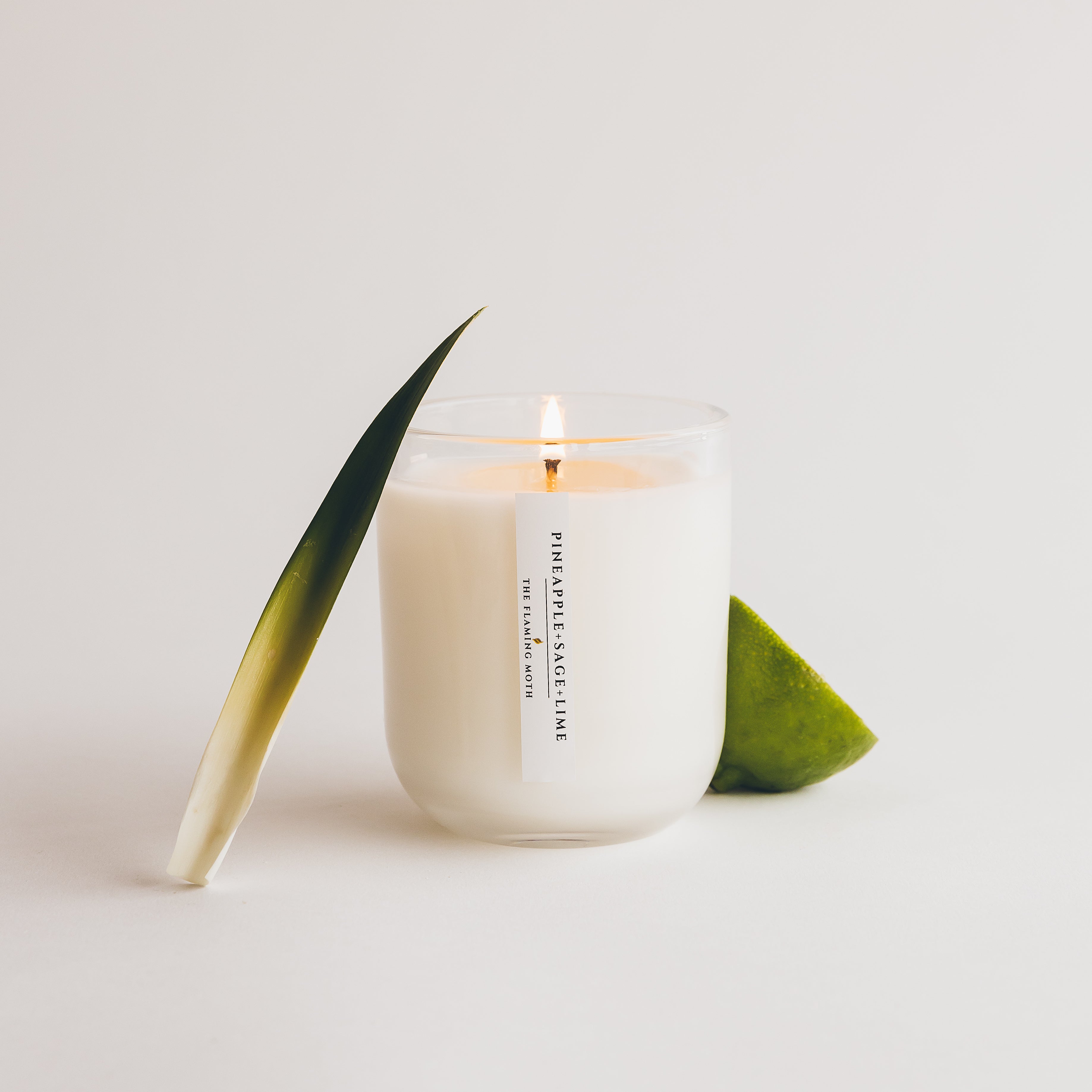 pineapple sage lime candle with a pineapple leaf and lime