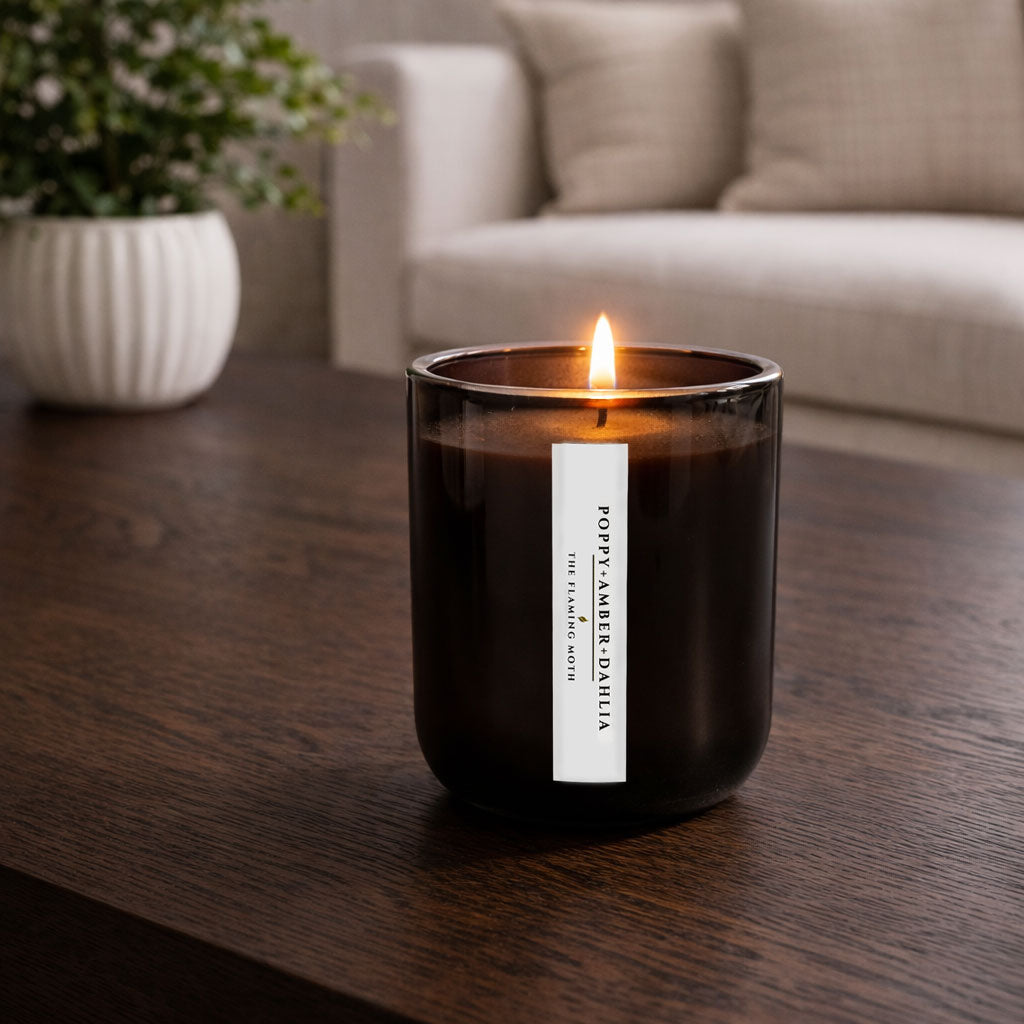 poppy dahlia amber candle on dark wood coffee table