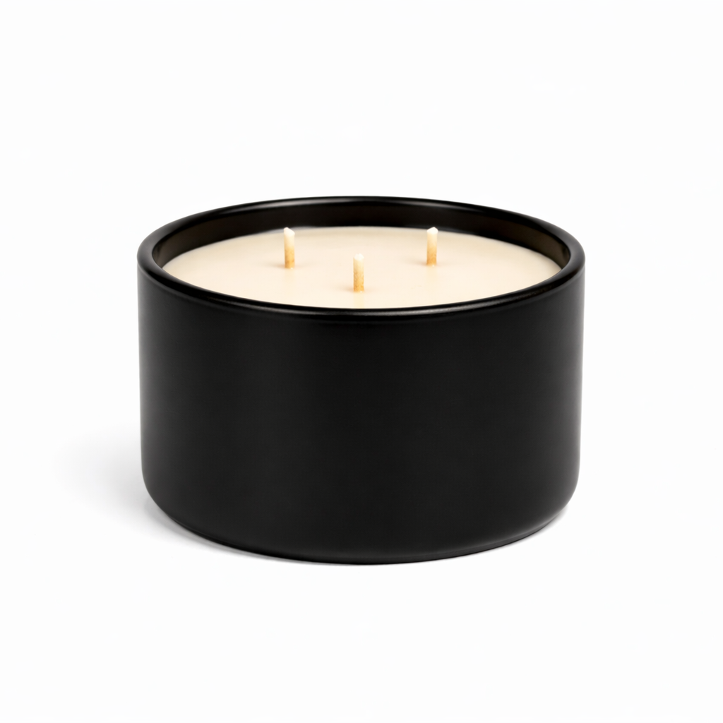 three wick candle in black ceramic vessel